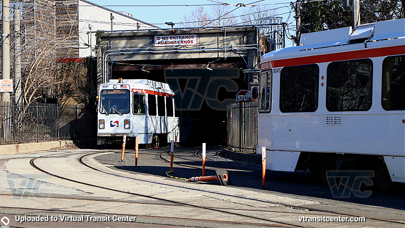 SEPTA 9000 Series Trolley Cars on the T4 and T3 at 40th Street Portal
9049 get's it trolley pole lubed (giggity) while 9047 emerges from Trolley Tunnel. 
