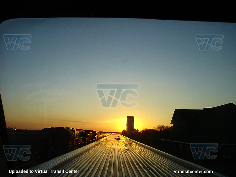 The Canadian 02, observation car, passing a cargo train
Photo taken on a cross-country train ride, we see a cargo train and the roof of 
